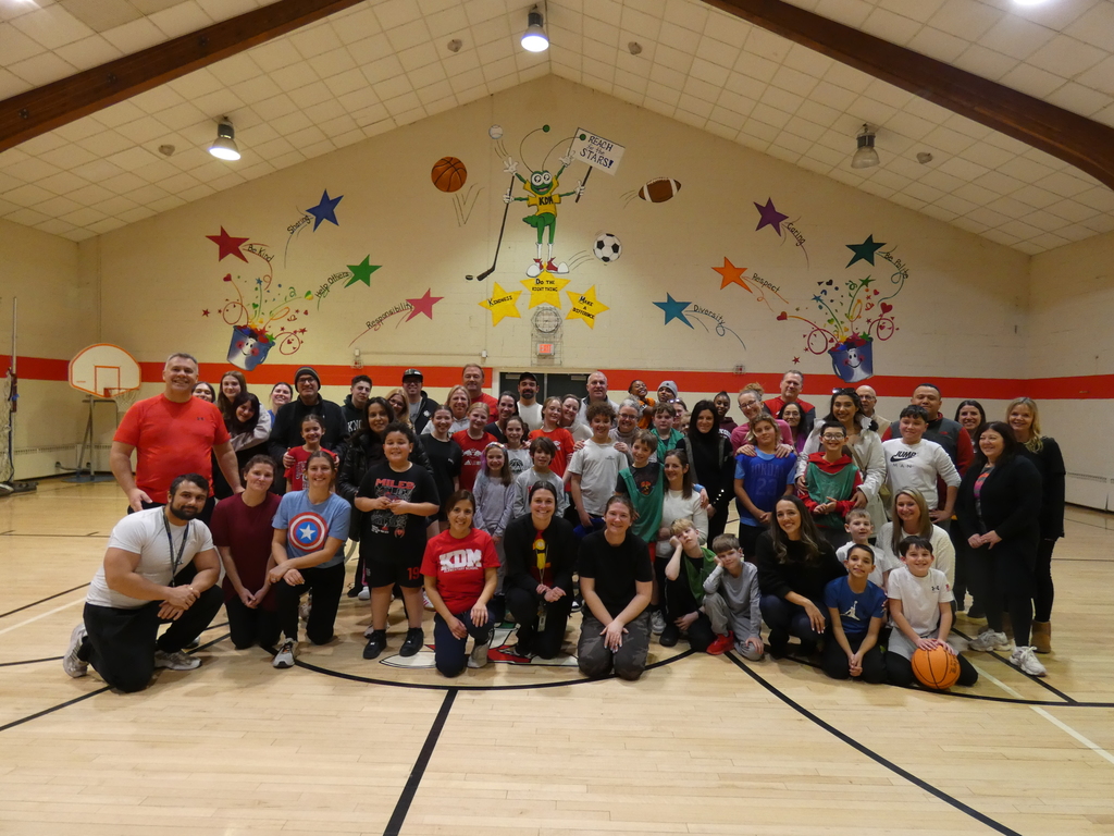 photo of teachers, students parents at the school gym after their friendly basketball game - The KDM Faculty and Staff Challenged the 5th Grade to a friendly game of basketball. A special thank you to Ms. Molloy for hosting a great event, the participating staff who are always great sports, Mr. T for returning as the honorary referee, and the parents and family members that attended, as well as those that were subbed into the game! Thanks for the reinforcement!