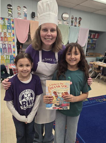 2 students reading and their teacher