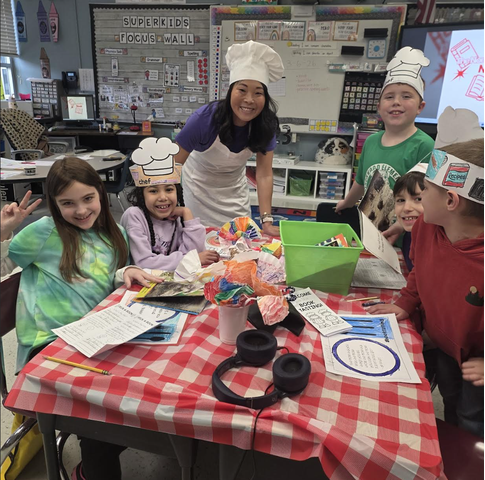 students and teacher posing at the reading table