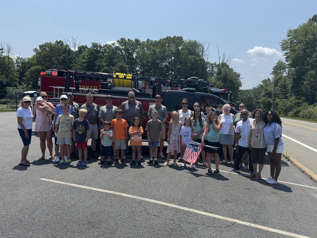 picture of staff , community members at the fire truck for the moving wall project