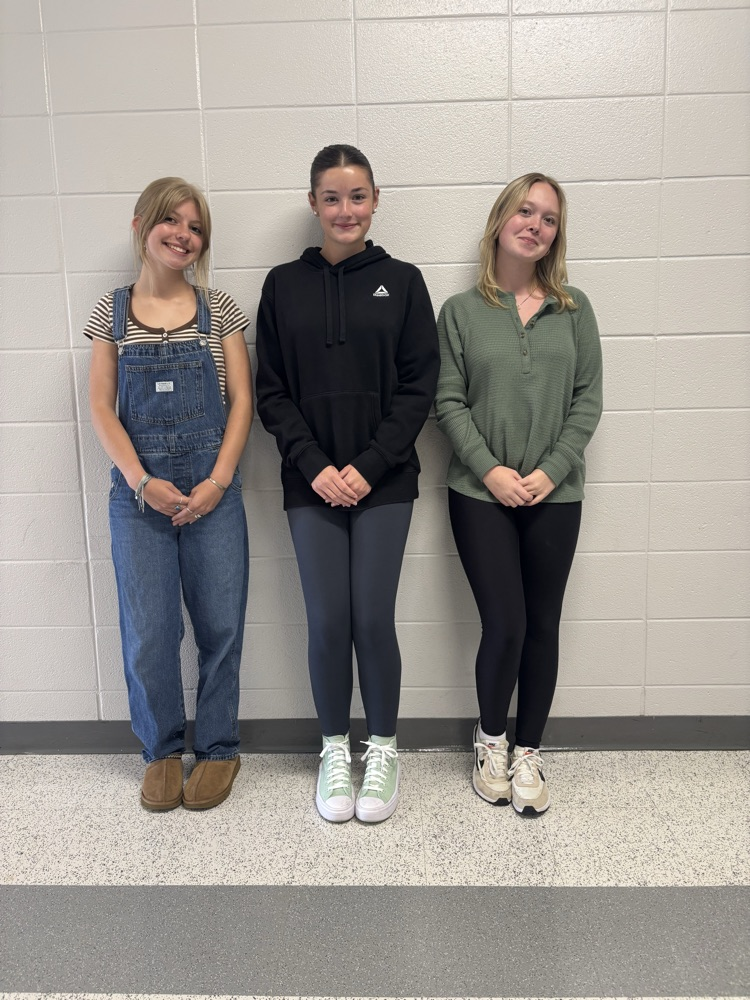 Three female students against the wall