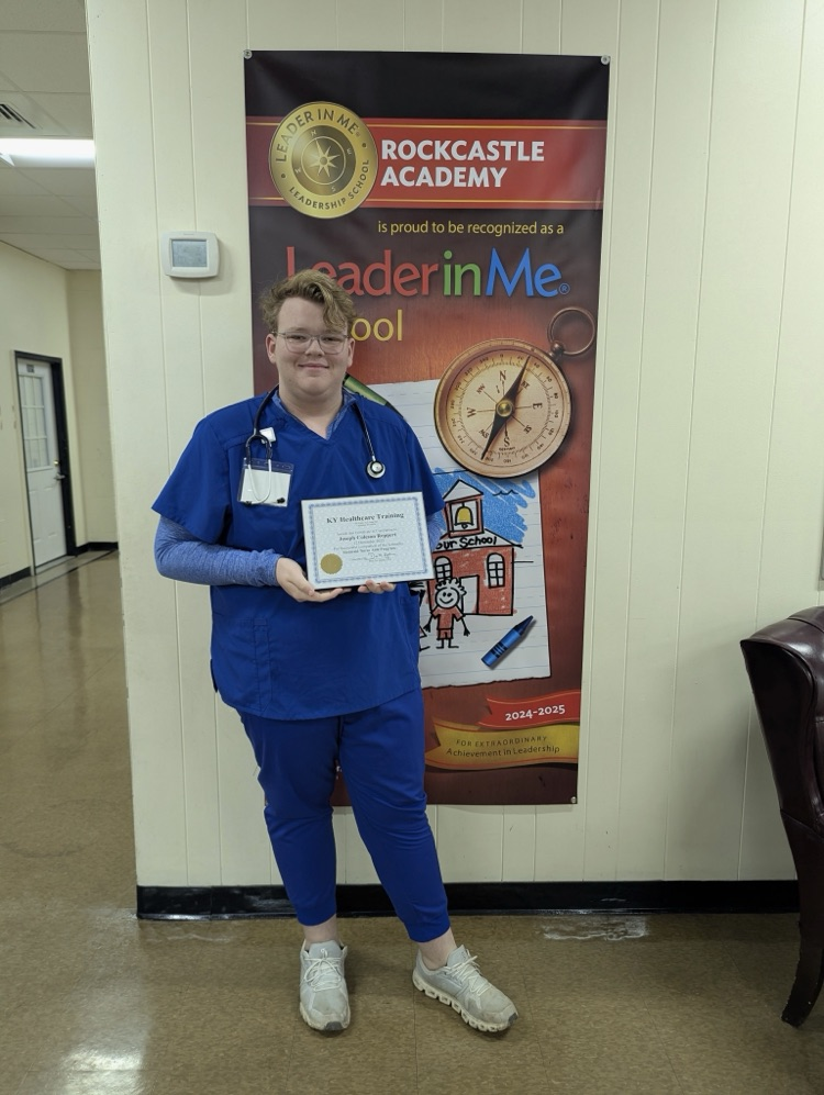 A student holds a certificate  