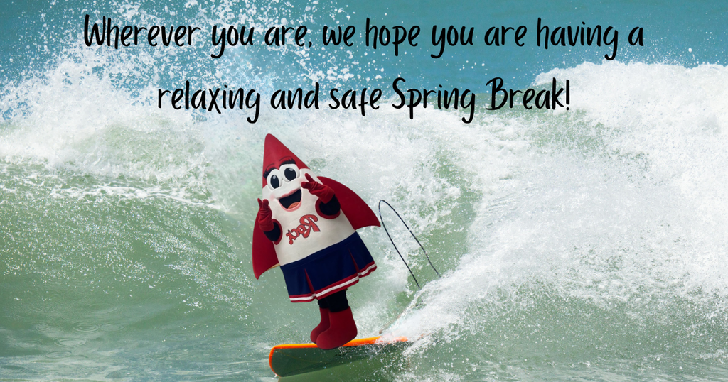 Roxie the Rocket mascot surfs a wave. 