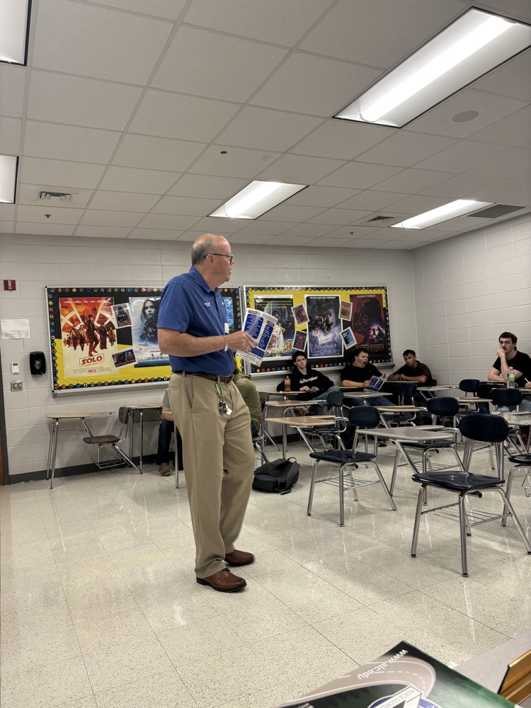 Mr. John Mills speaks to a class of seniors.