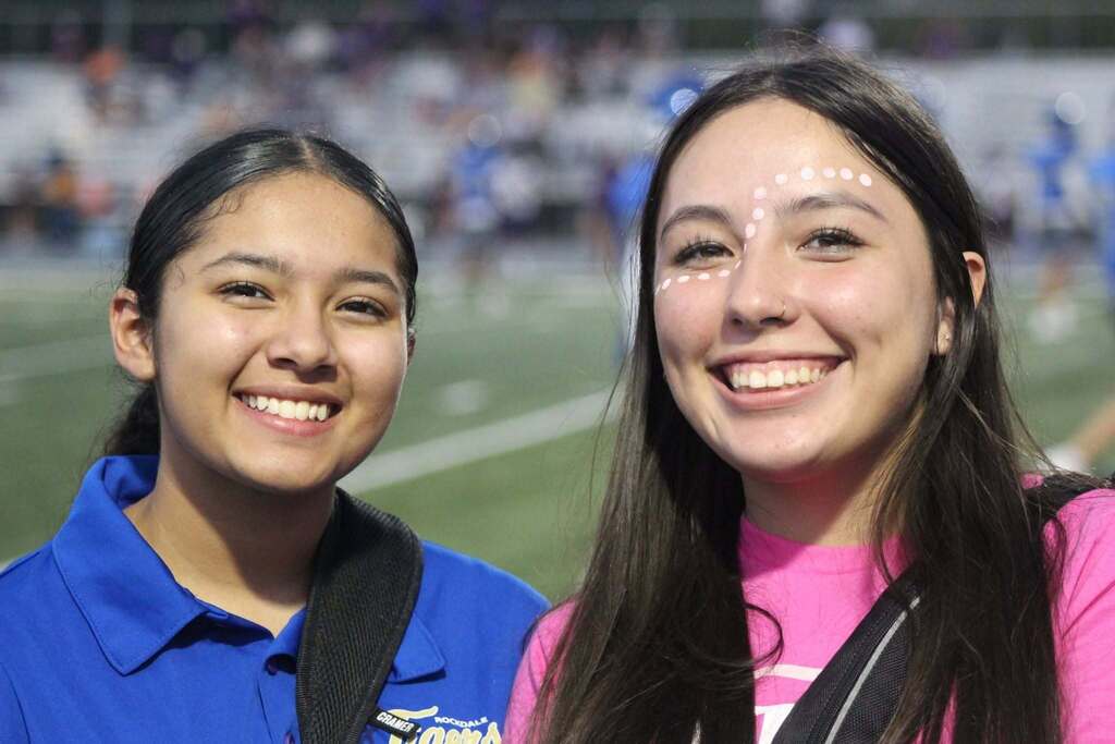 Two girls standing together smiling