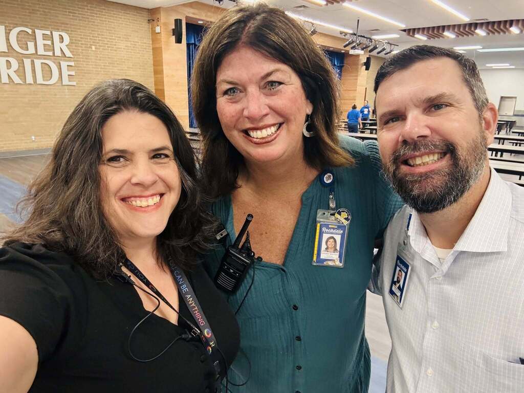 Counselor, assistant superintendent and superintendent standing together smiling