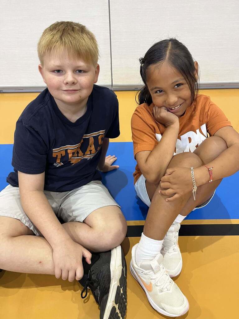Two students sitting together and smiling