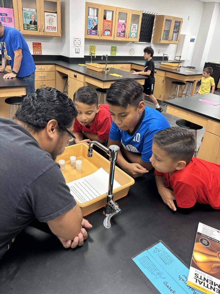 Family of four watching a science experiment