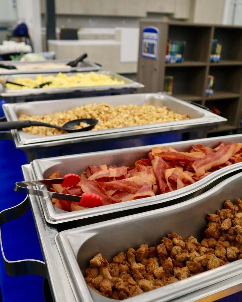 Eggs, potatoes, bacon and sausage in catering trays