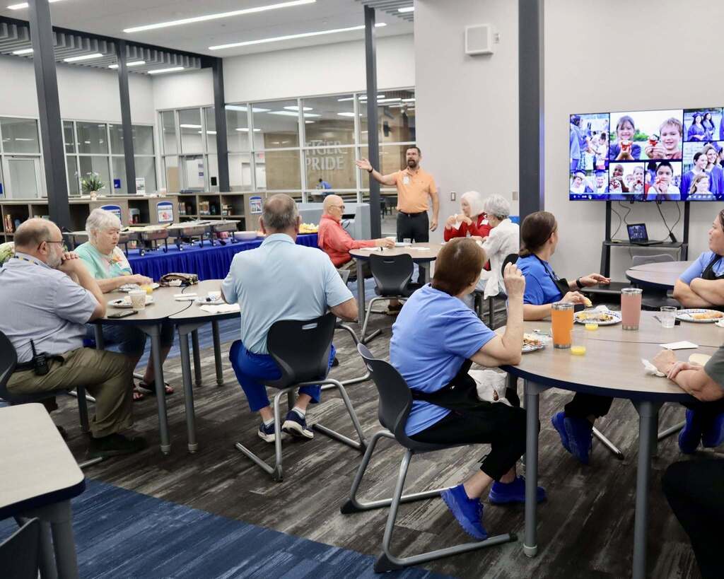 Groups of people sitting together and eating.