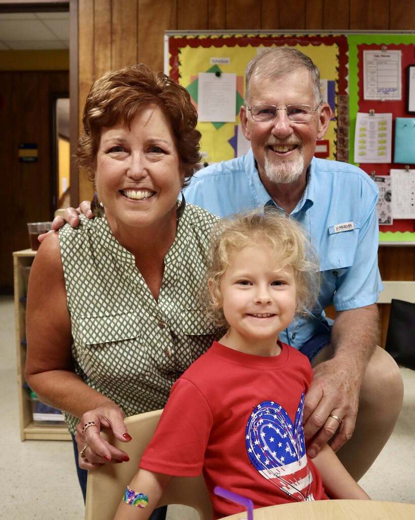 Grandparents with their grandchild, smiling