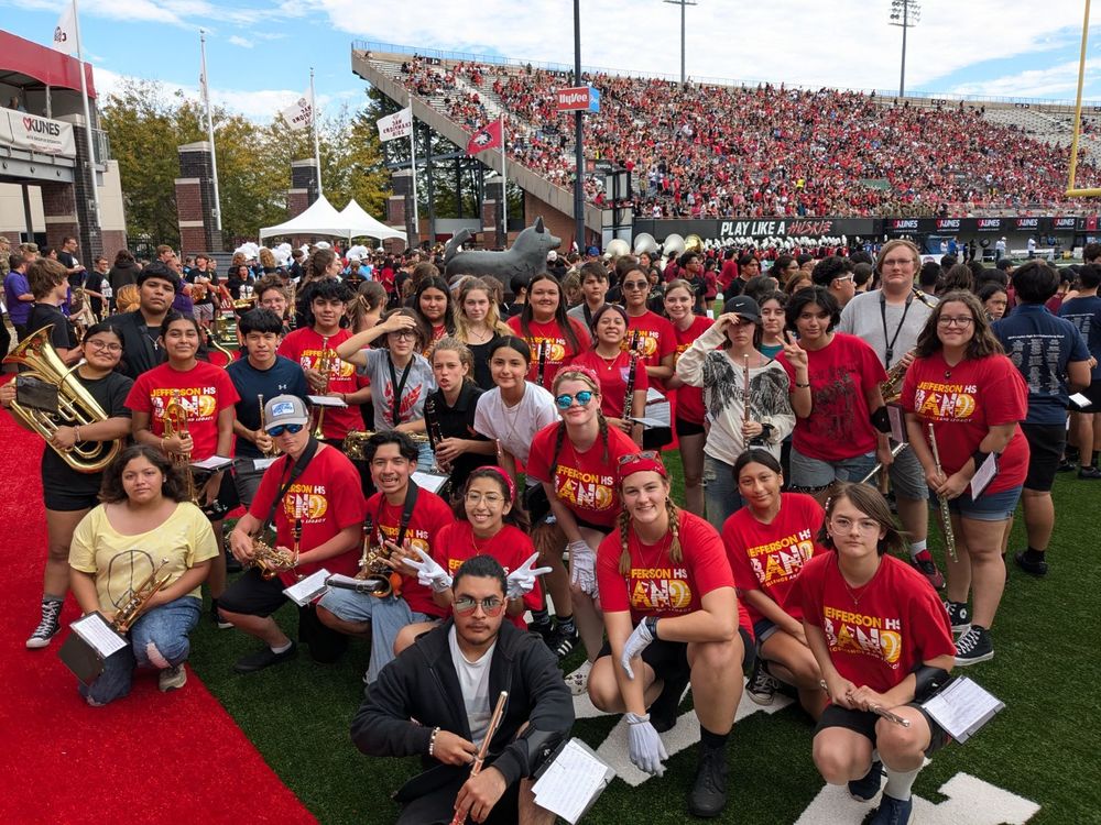 Band poses for a photo at Huskie Stadium