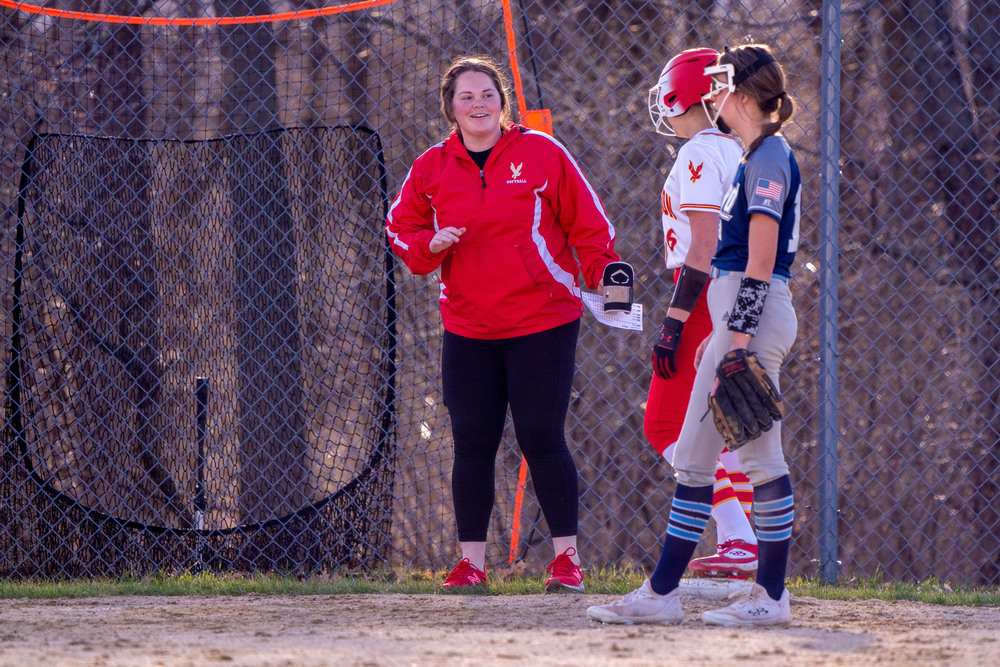 Coach Cason talks to her baserunner