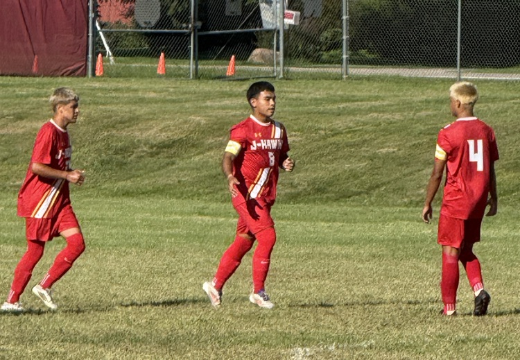 Marquez high fives teammates after a goal