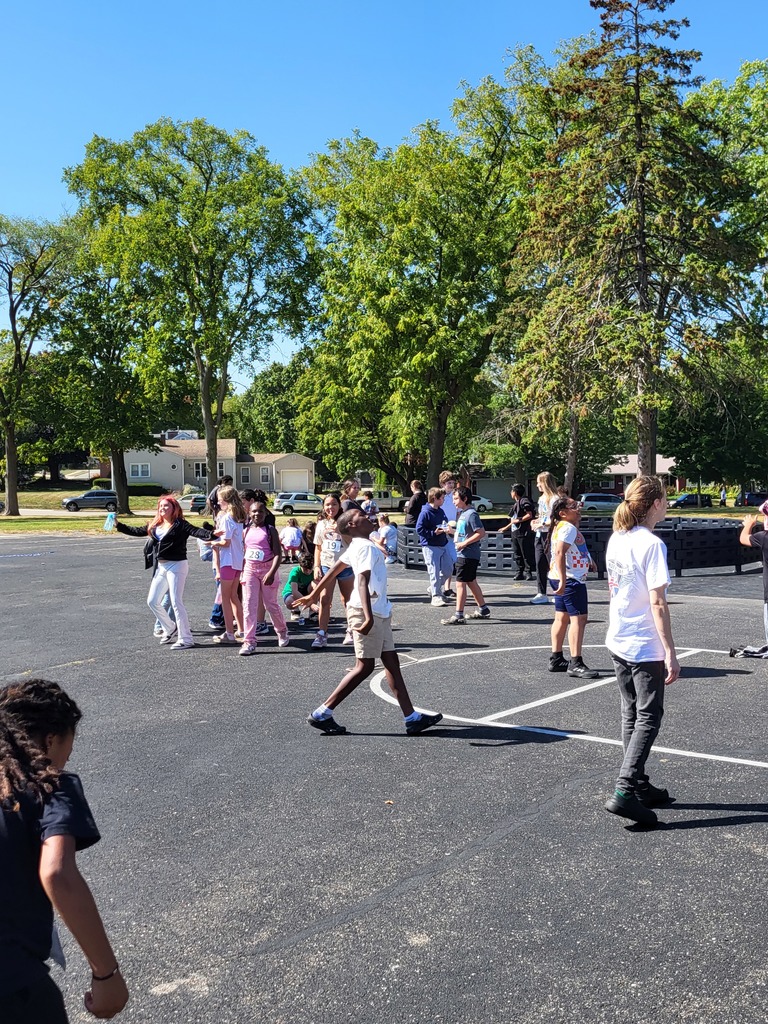 Students walking on blacktop.