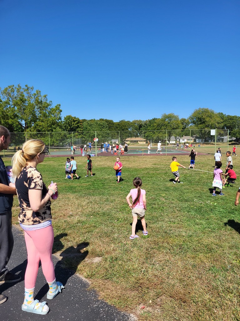 Students playing games on a field.