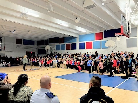 Mrs. Janitzky leading students in song.