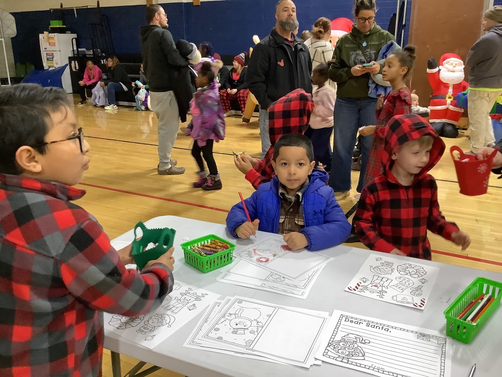 Students coloring in the gym.
