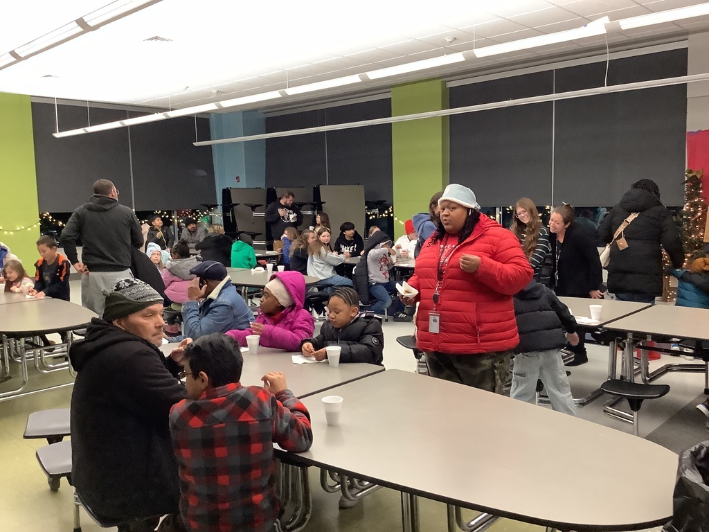 People sitting and standing drinking hot chocolate.