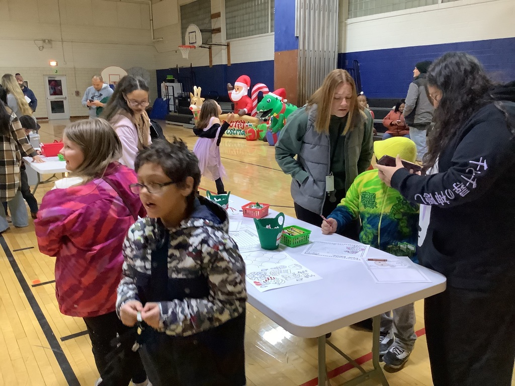 Students and adults in a gym coloring.