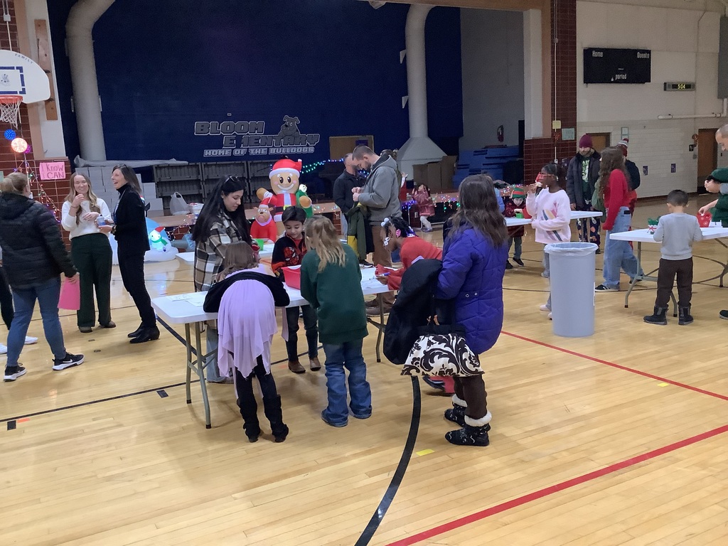 People in a gymnasium talking.