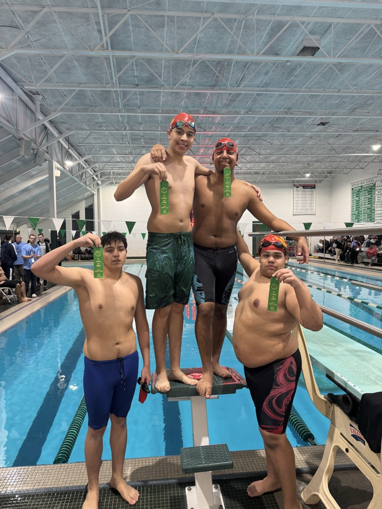 the swimmers pose with their medals