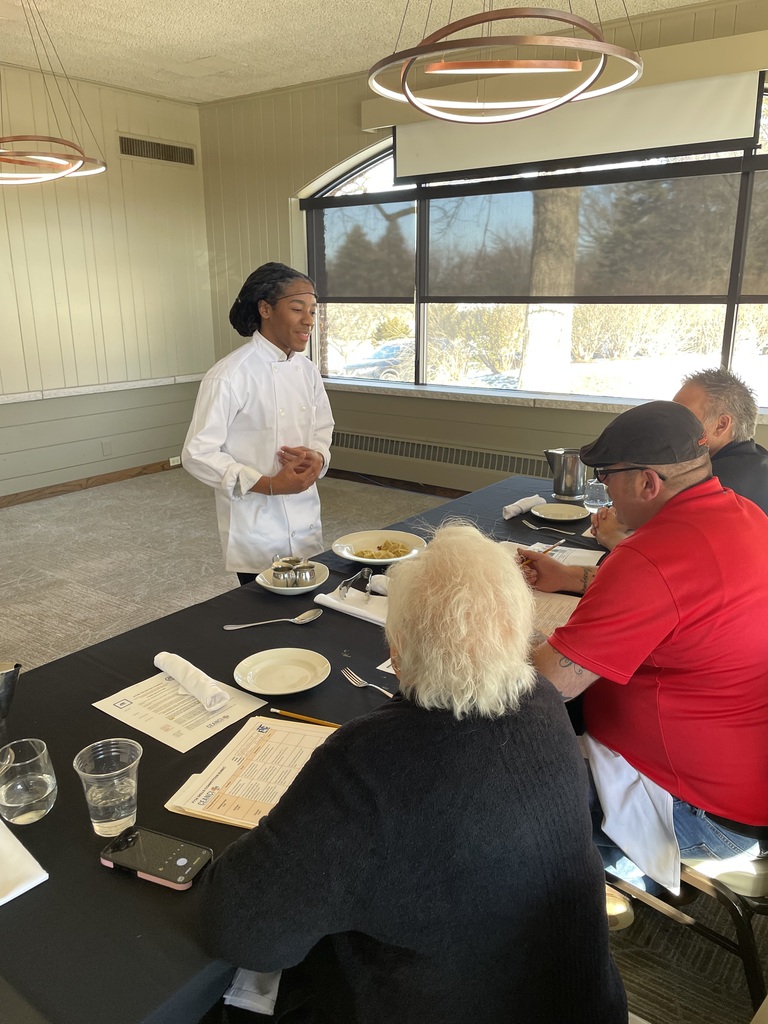 Student presenting pasta to judges 