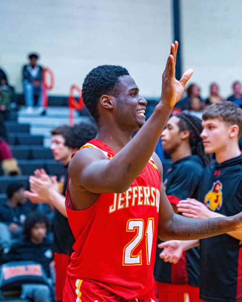 Basketball student has hand up and is waving