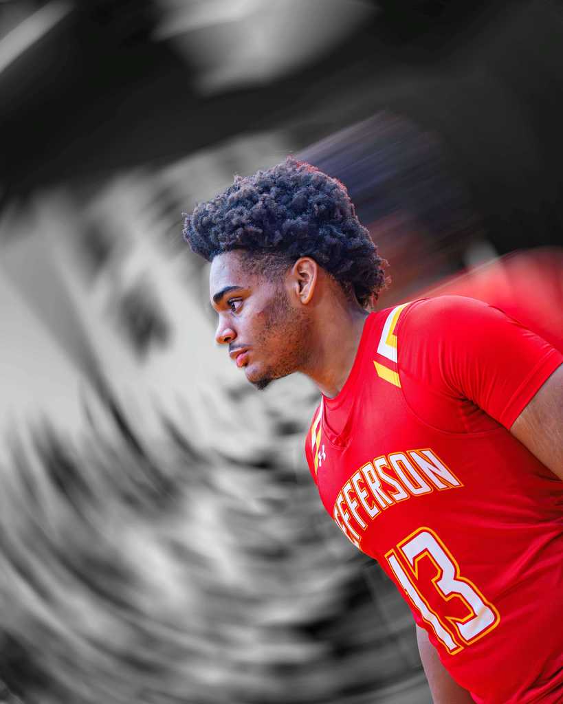 Athlete looking off to the side, picture is a side profile picture.