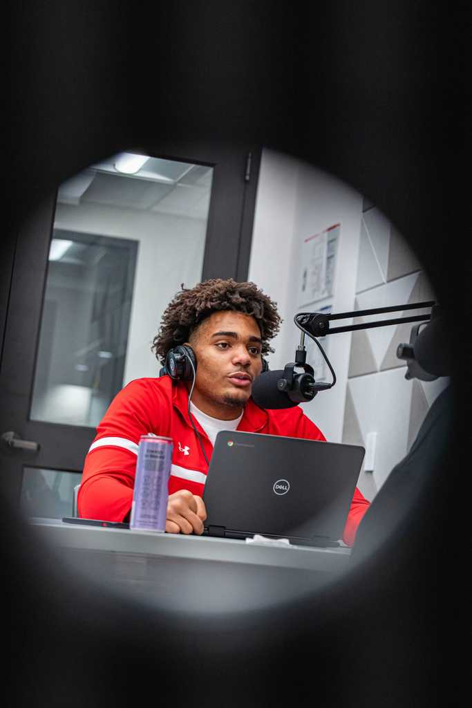 Student asking a question in a podcast room