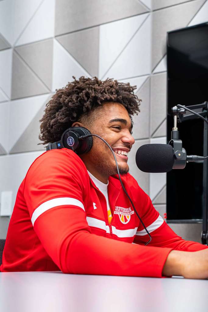 Student smiling in podcast room