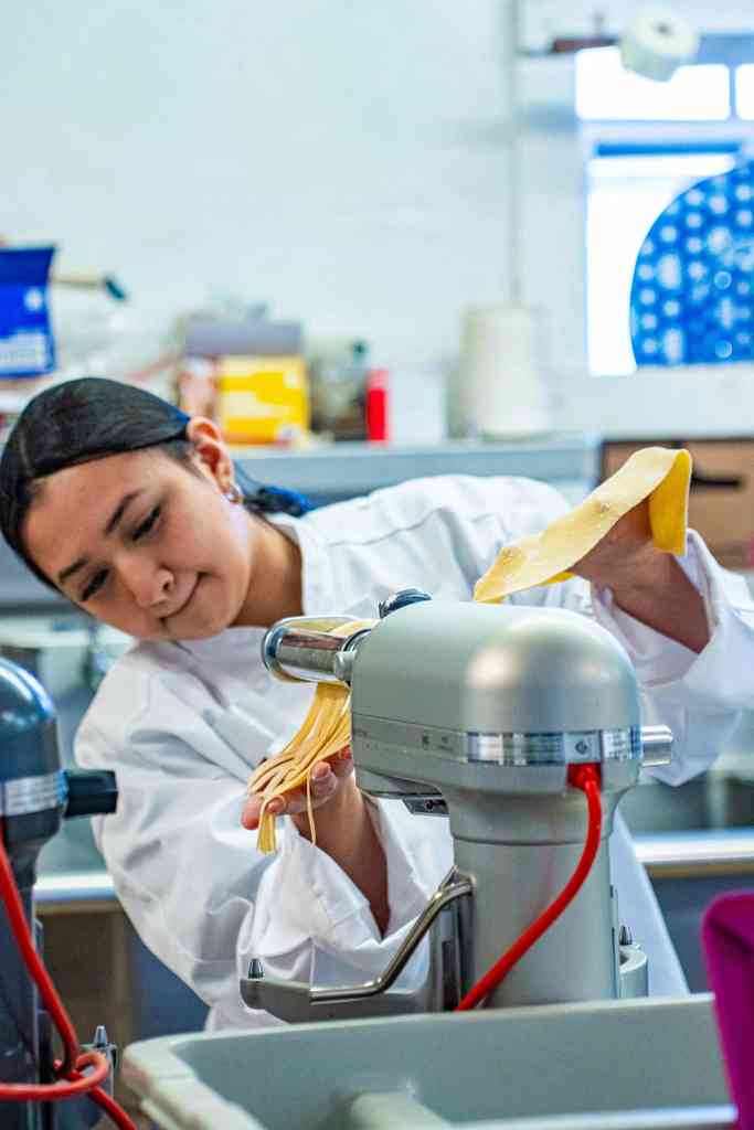 Student making pasta.