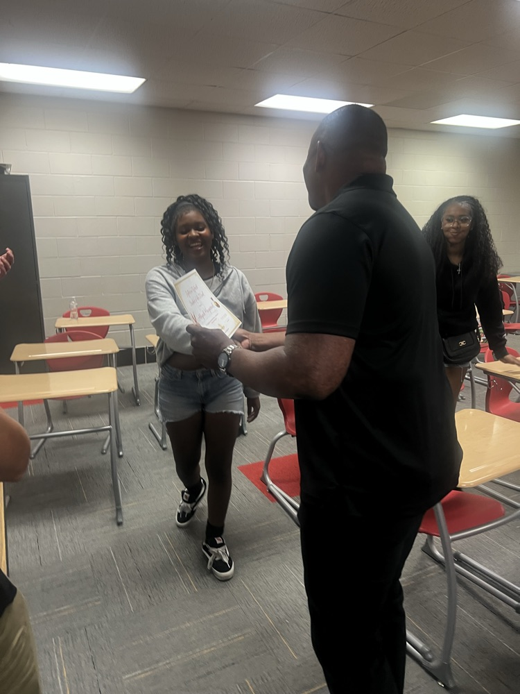 dr. Huff congratulates a student