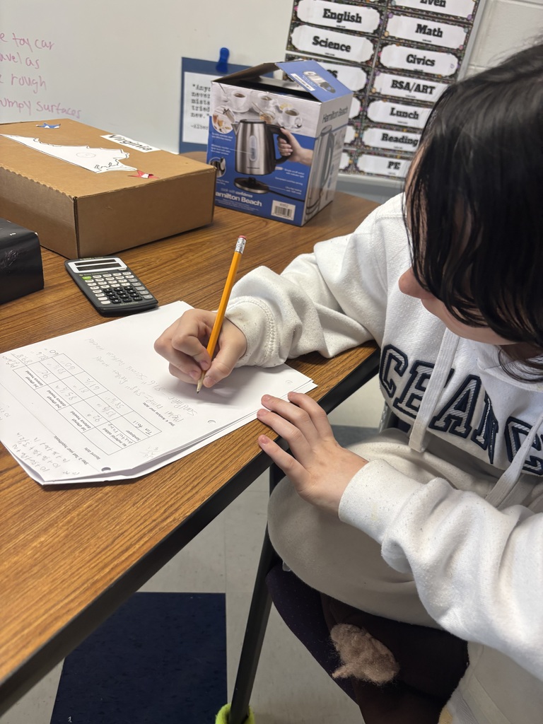 student writing down results