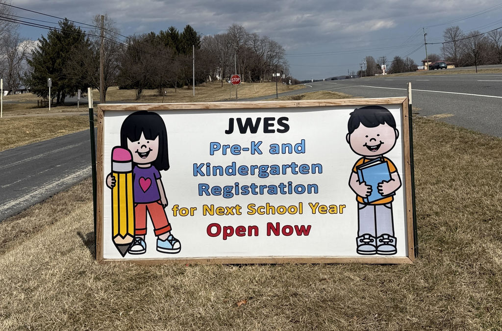 Sign with cartoon children advertising Pre-K and Kindergarten registration open for the 2026-2027 school year.