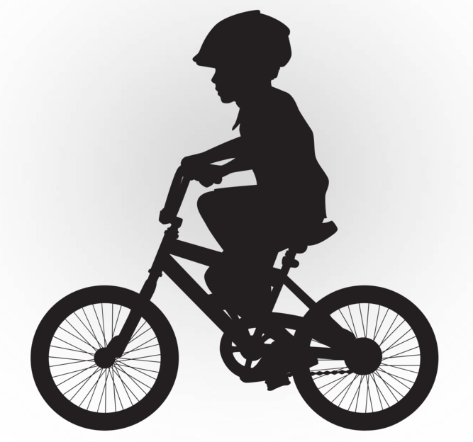silhouette of a child riding a bicycle