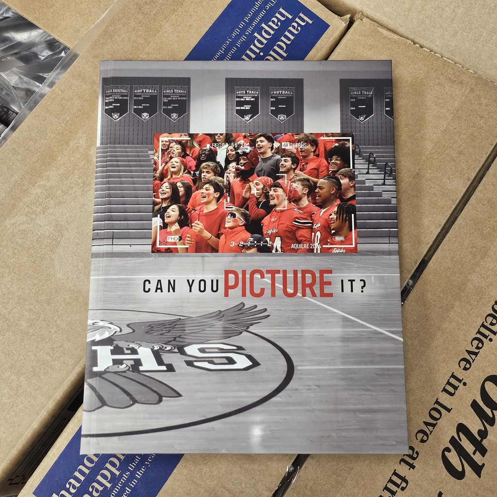 A yearbook cover with a photo of fans in red jerseys and a title.