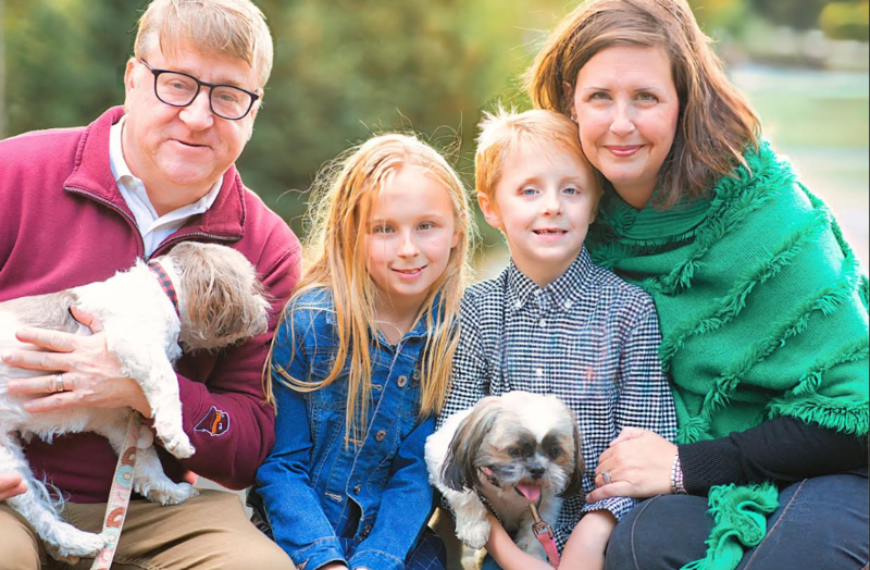 Mrs. Elkins in pictured in a family photo with her husband, two children, and two dogs. 