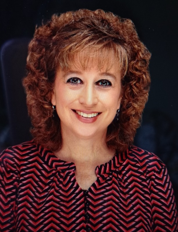 Mrs. Furry is pictured in a professional photo with a black background