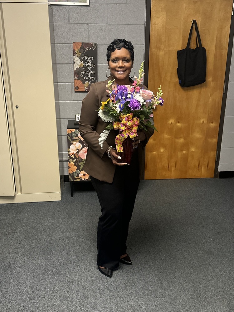 RMS Classified employee holding flowers