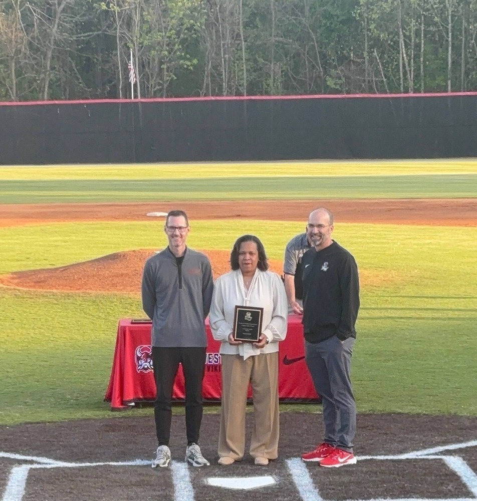 Picture of Ms. Siddle receiving her award on the field