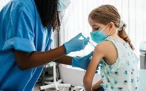 Nurse giving a shot to a child.
