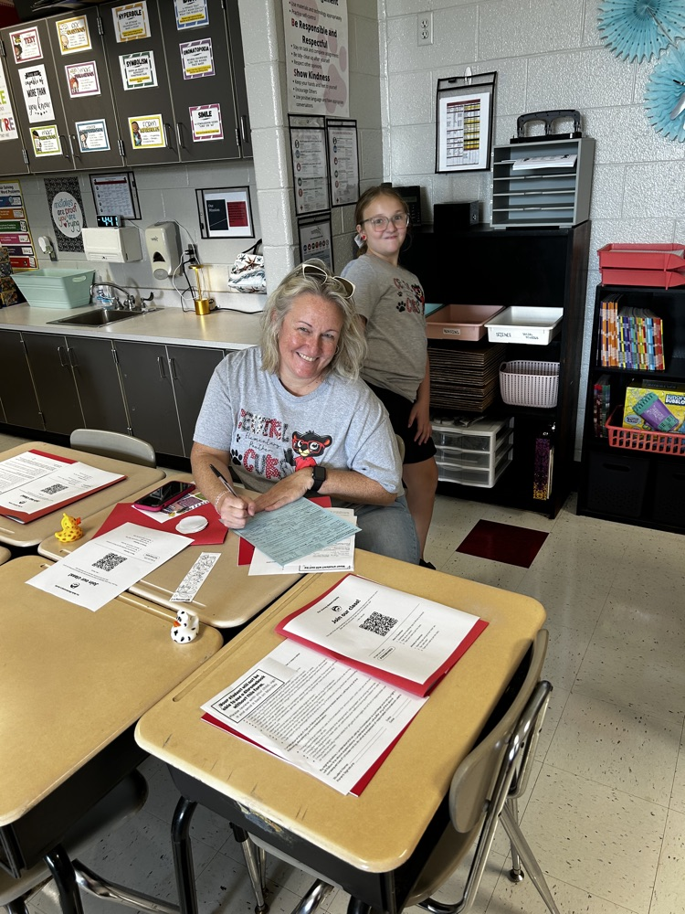 parent and child filling out registration paperwork