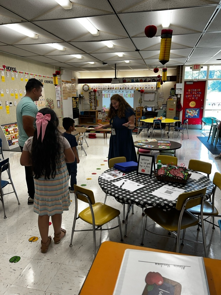 students gather in classroom with new teacher