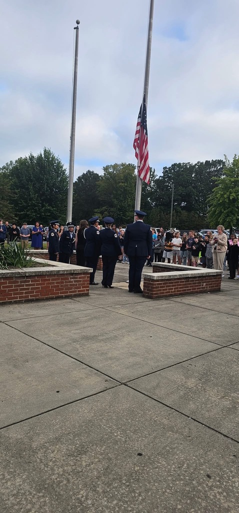 Students at half staff flag