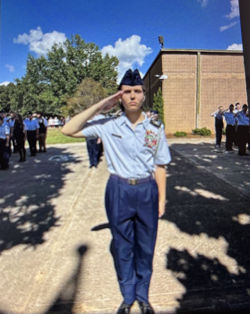 Lone female ROTC cadet salutes the flag