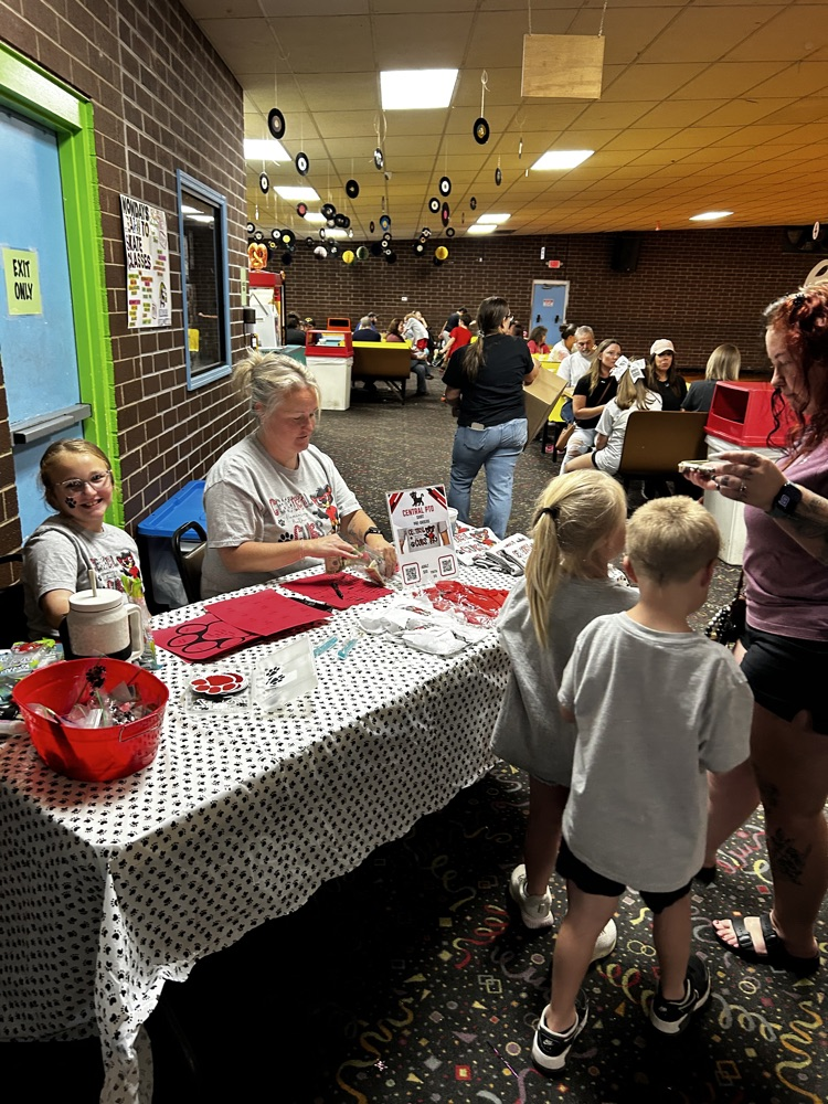 Central students visit the Spirit Wear table at Skate Night. 