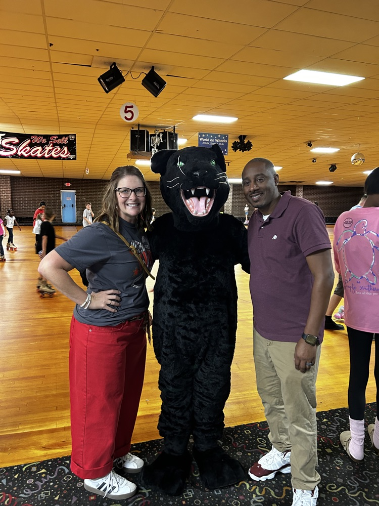 our principals smile with our school mascot. 