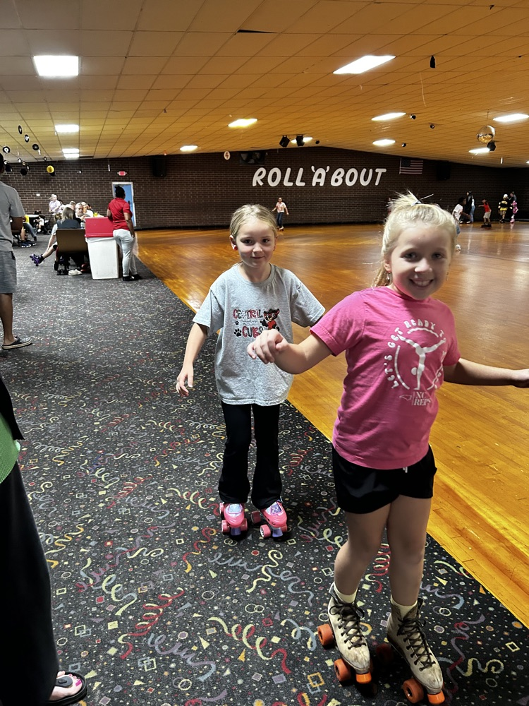 two girls skate on the carpet 