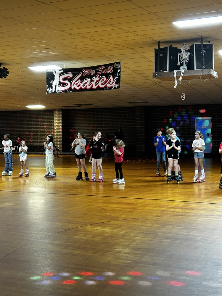 students skate together in the skating rink 